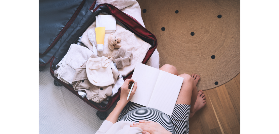pregnant-mum-sat-on-bed-packing-suitcase-for-birth-bon-and-bear