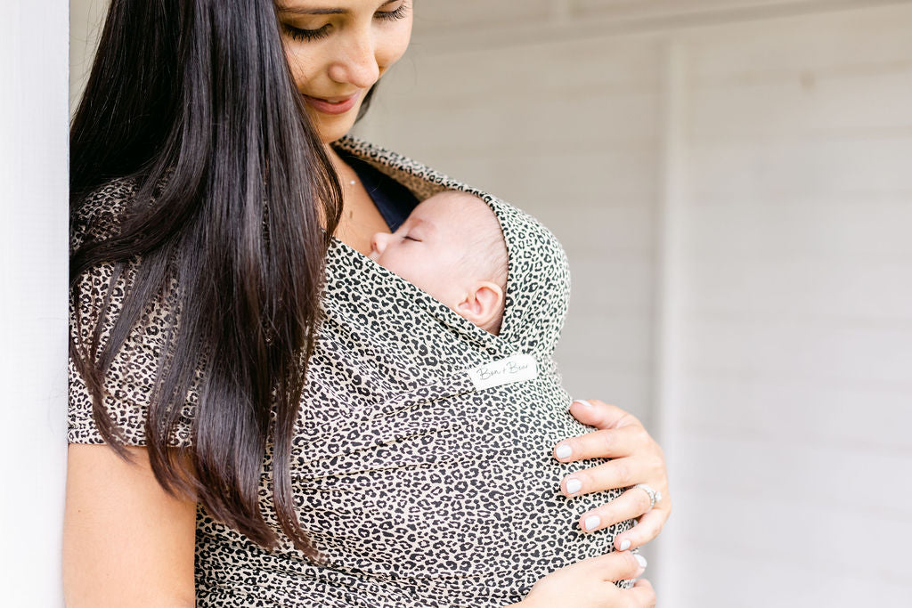 mum-smiling-down-at-baby-in-leoaprd-print-baby-wrap-bon-and-bear