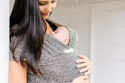 mum-smiling-down-at-baby-in-leoaprd-print-baby-wrap-bon-and-bear
