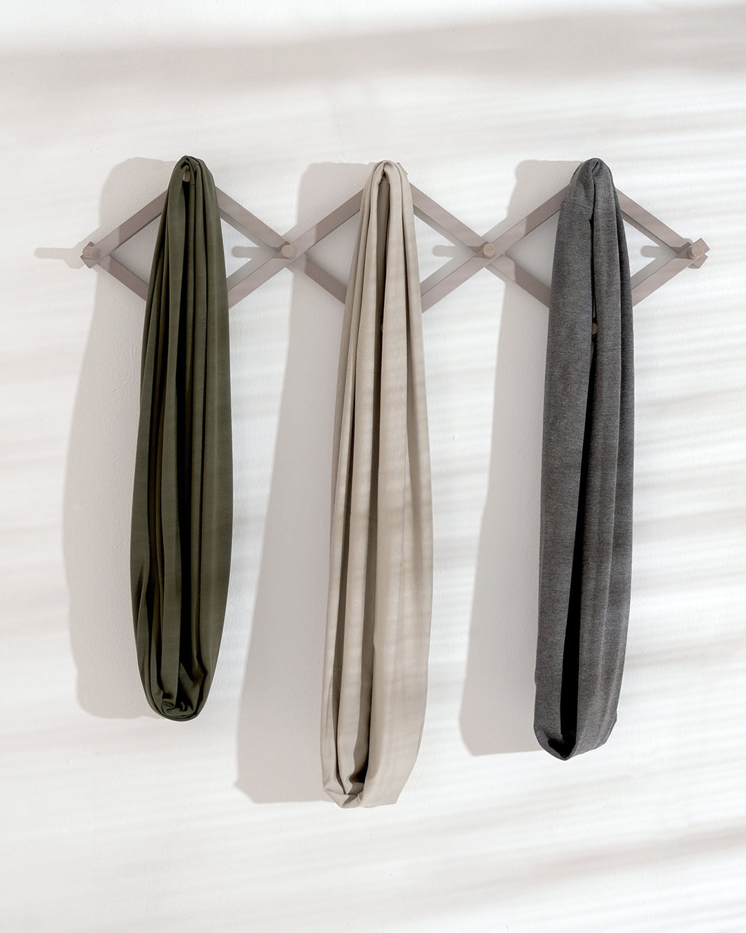 khaki-pale-grey-slate-grey-neutral-breastfeeding-covers-hung-on-peg-rack-bon-and-bear