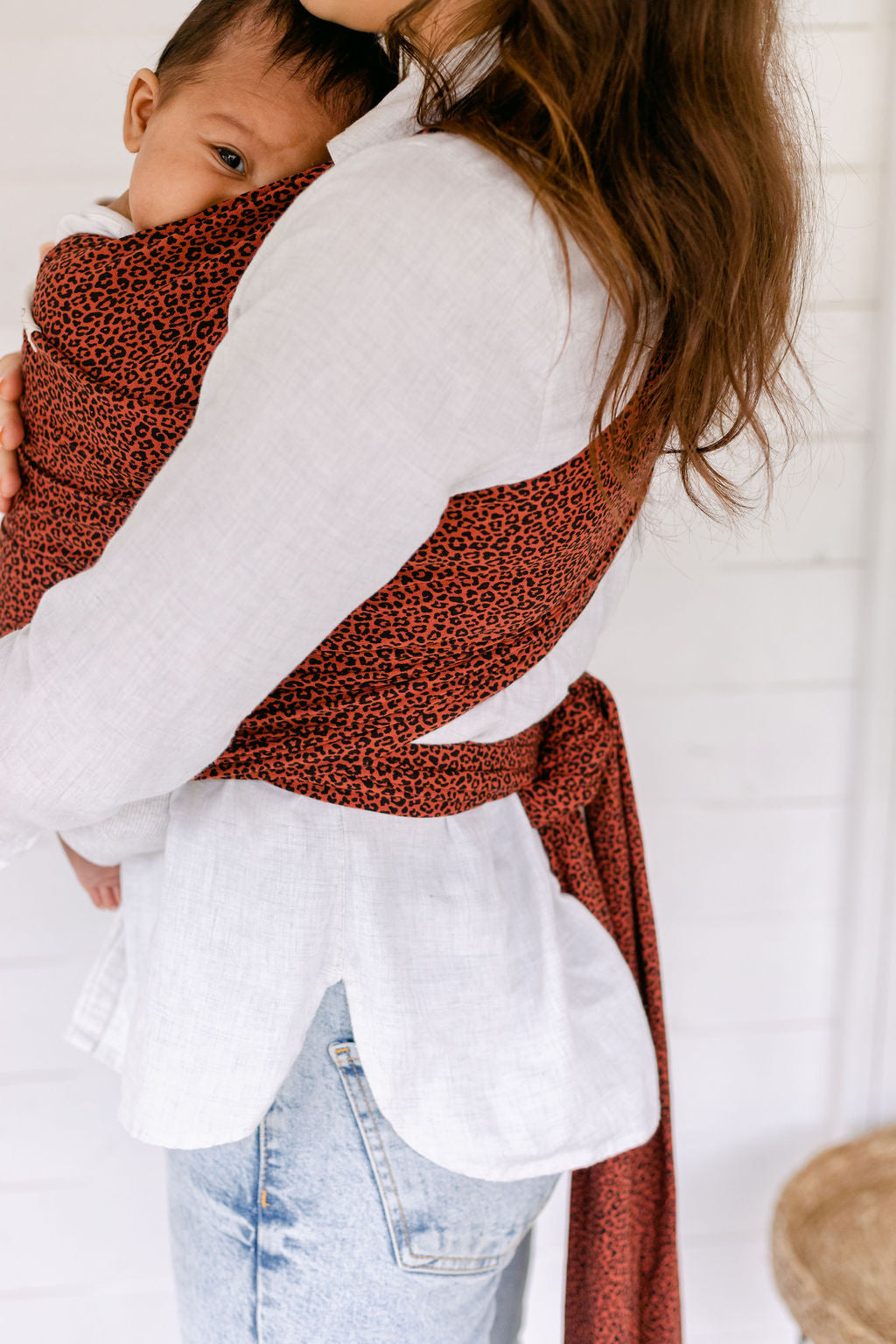 baby-looking-out-hugging-mums-chest-in-red-leoaprd-print-baby-sling-wrap-bon-and-bear Edit alt text