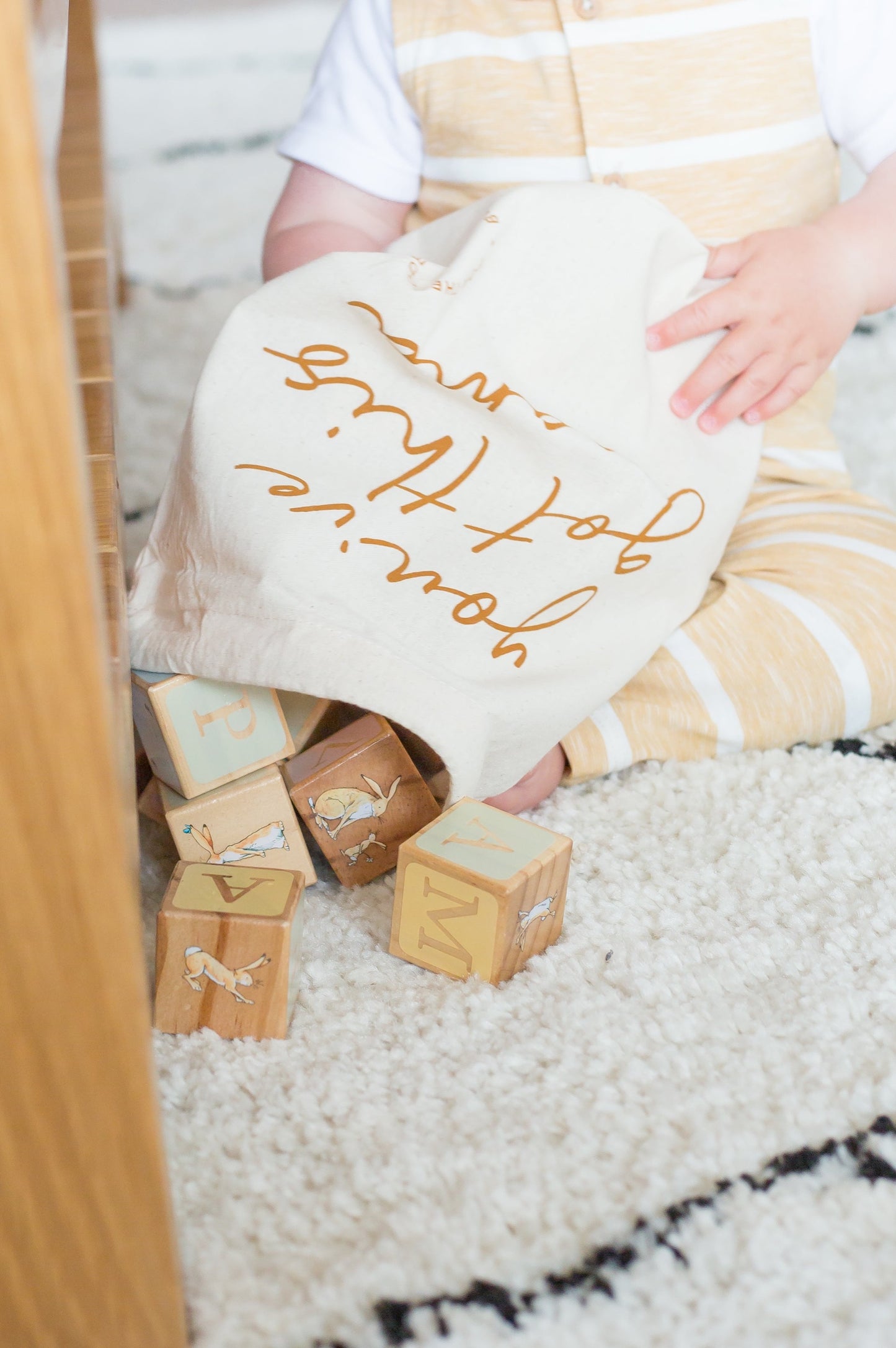 baby-sat-on-rug-emptying-drawstring-bag-of-wooden-blocks-bon-and-bear