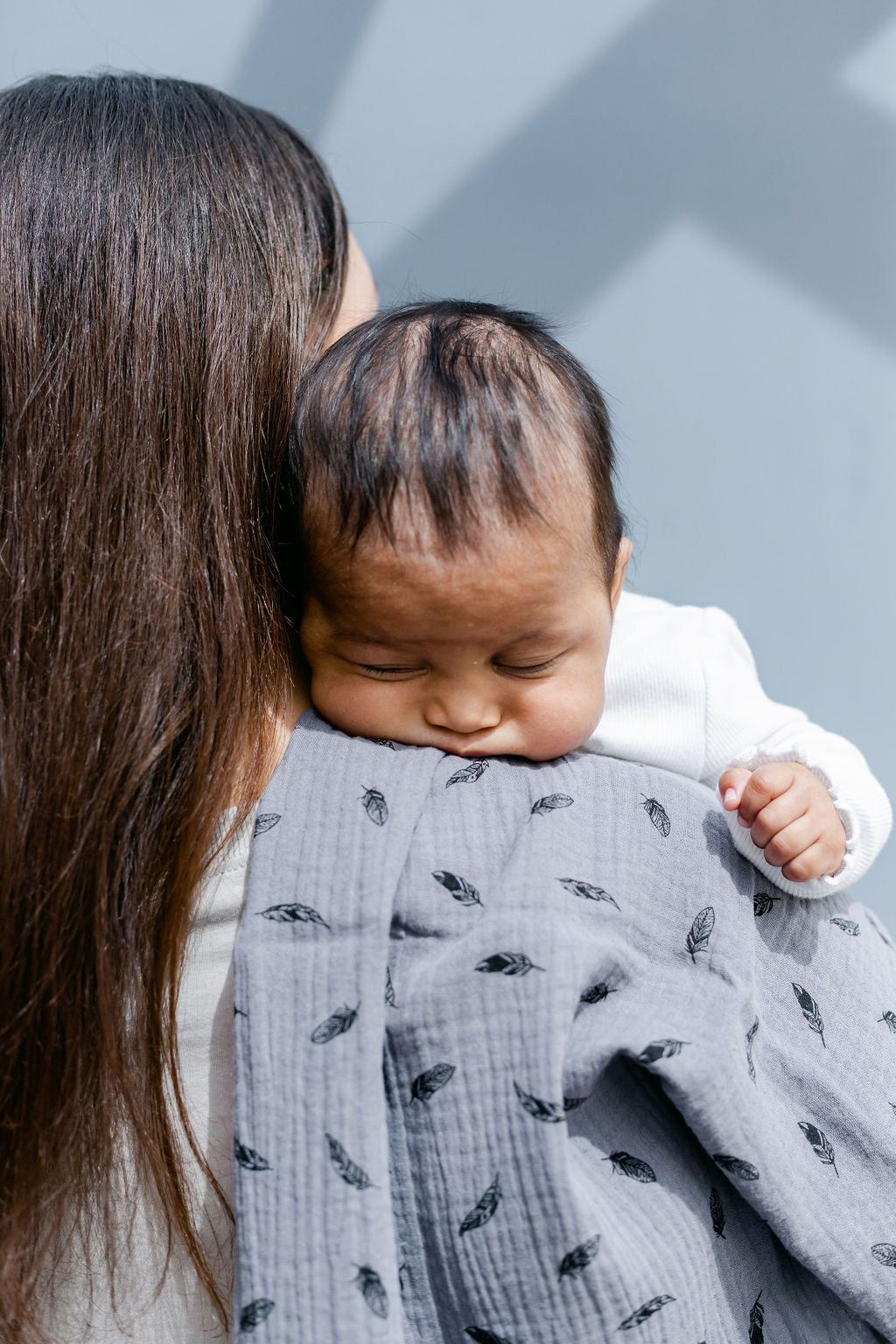 baby-sleeping-over-mums-shoulder-with-grey-feather-print-muslin-over-shoulder-bon-and-bear