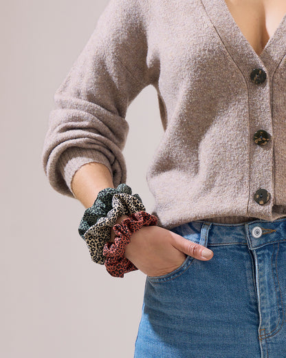 multi-leopard-print-3-hair-scrunchies-on-wrist-with-hand-in-jeans-pocket-bon-and-bear